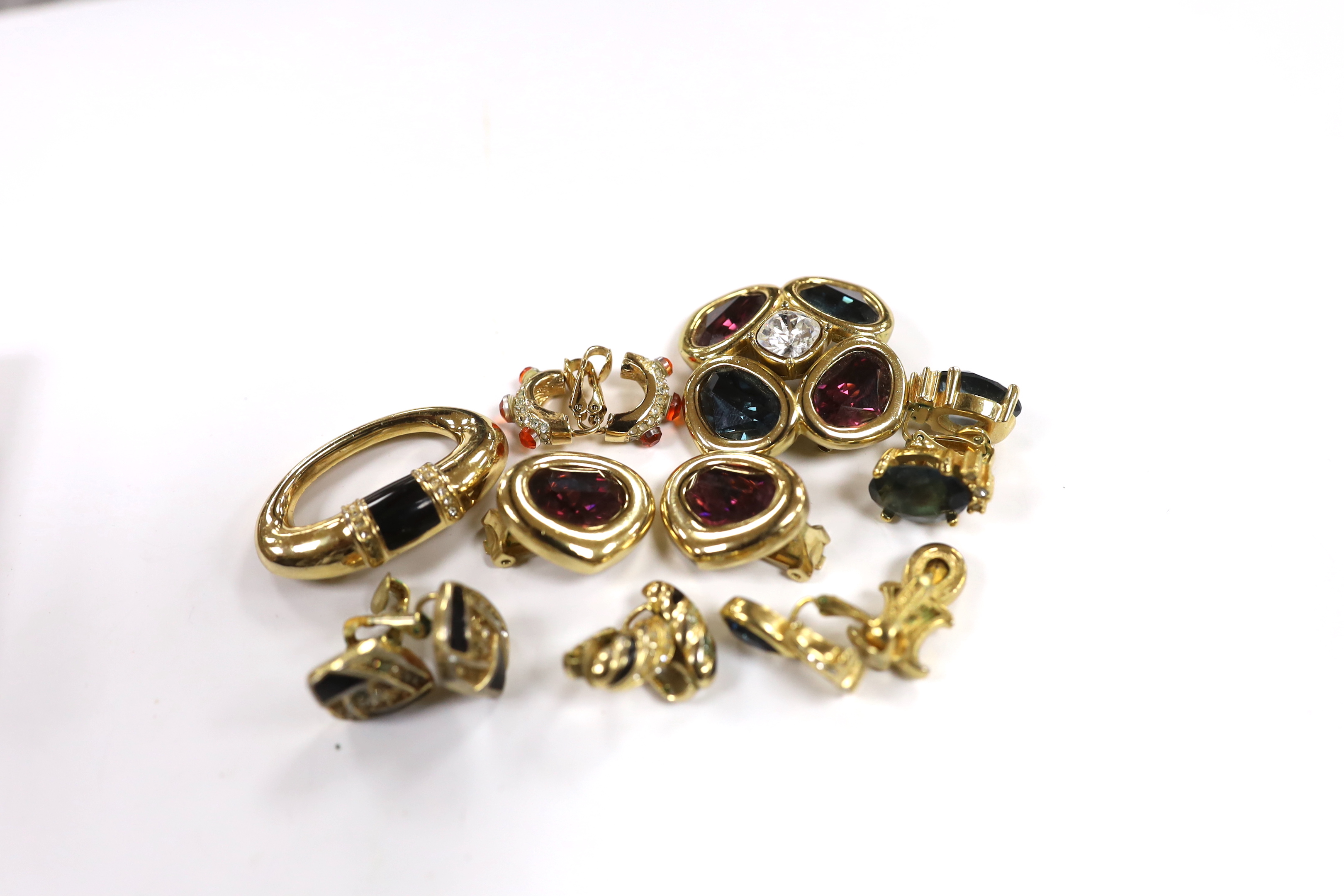 A Christian Dior gilt metal and coloured paste set quatrefoil brooch, 37mm and pair of similar ear clips, five other assorted pairs of Dior ear clips and a Dior brooch.